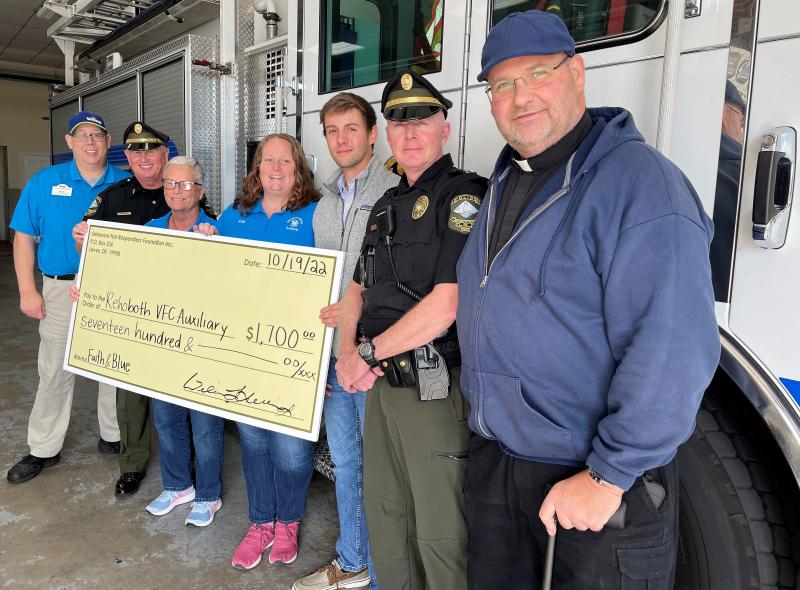 Check presentation attendees shown are (l-r) Wawa Assistant General Manager Scott Furman, Rehoboth Beach Police Chief Keith W. Banks, Debbie Marsch and Katy Miller with the RBVFC Auxiliary, volunteer and former seasonal officer Luke Biller, Lt. Will Sullivan and Father William Cocco, St. Edmond’s pastor. SUBMITTED PHOTO